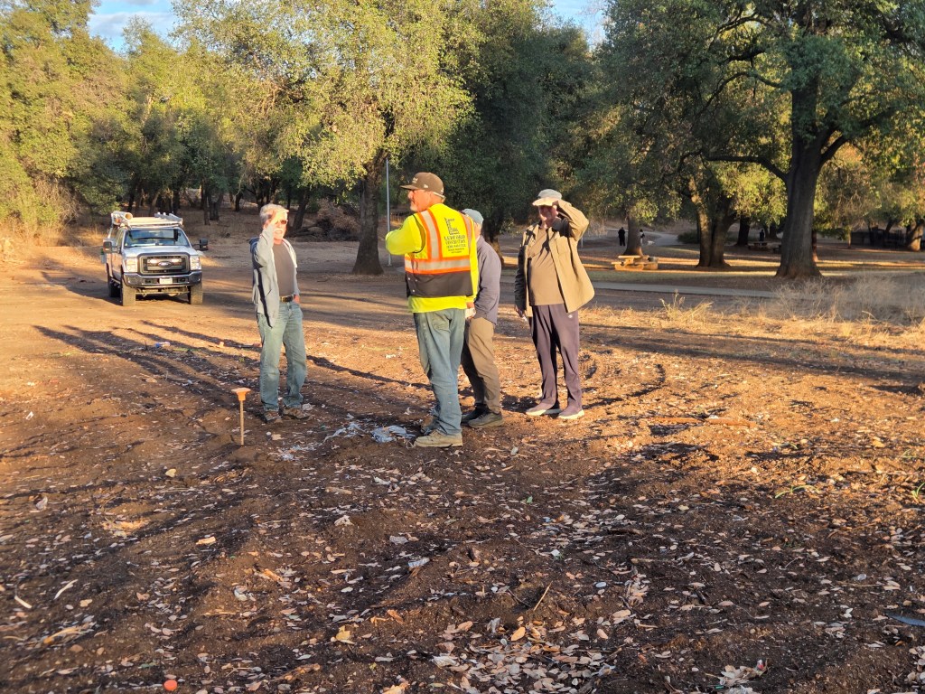 David Ledford of Ledford Concrete Services discusses the planned location of the Tai Chi court with Board members